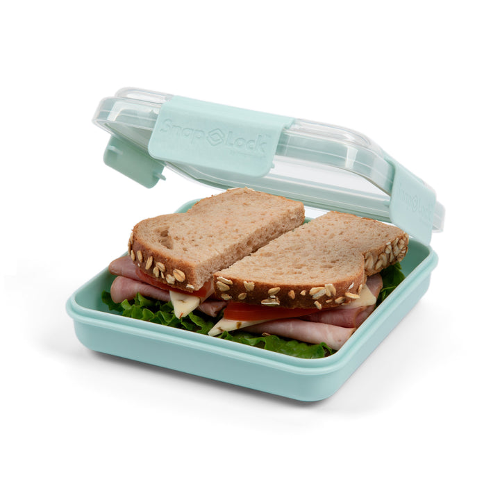 light blue plastic food storage container lunch box with open lid revealing a sandwich with tomato, pepper jack cheese, ham, and lettuce