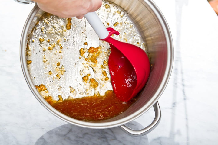 Scoop designed to scrape last bits from canning pan