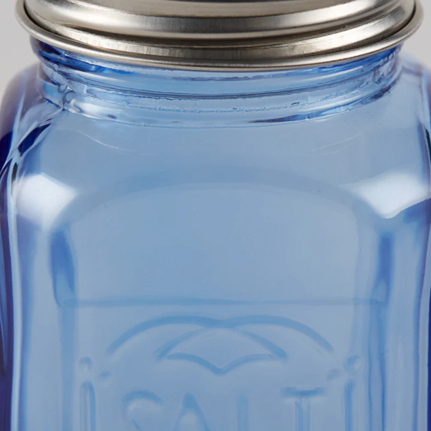 closeup of empty blue glass vintage salt shaker